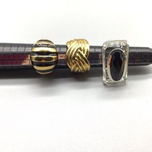 Lot of three gold tone and silver tone rings.